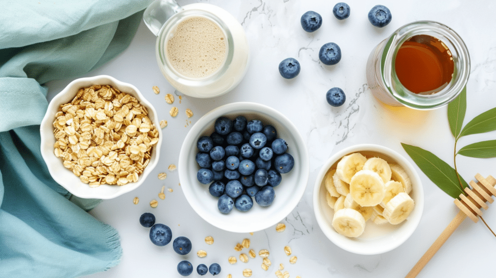 Overhead flat lay of Low FODMAP Rice Krispies bowl ingredients with blueberries, banana, and maple syrup