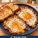 Two fried eggs with lacy golden-brown crisp edges, glossy orange yolks and black pepper beside toast on a navy plate